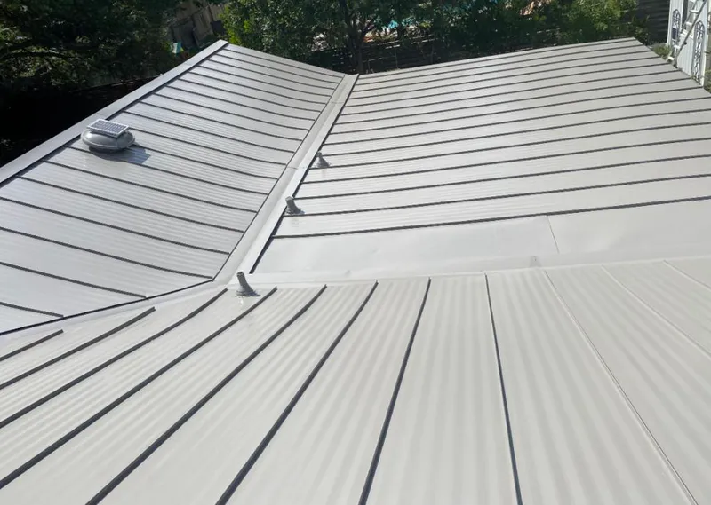 Solar attic fan installed on a metal roof for Roof Ventilation in Eureka